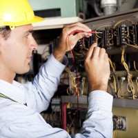 electrician testing industrial machine